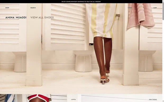 Amina Muaddi homepage on desktop, Shopify luxury footwear storefront captured at 1440 x 900